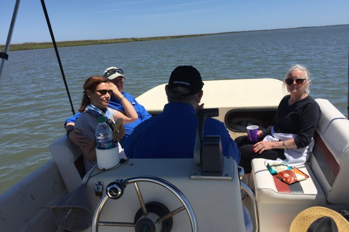 passengers sitting at the front of the boat
