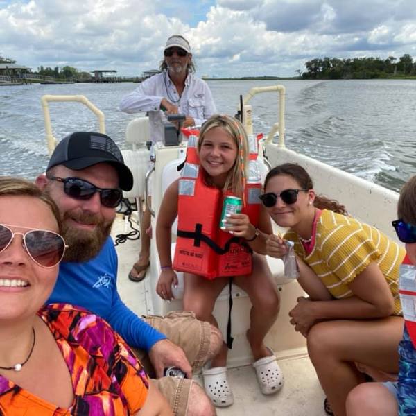 a group of people in a boat on a body of water