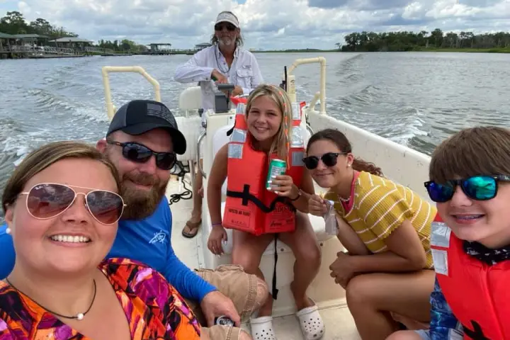 a group of people in a boat on a body of water