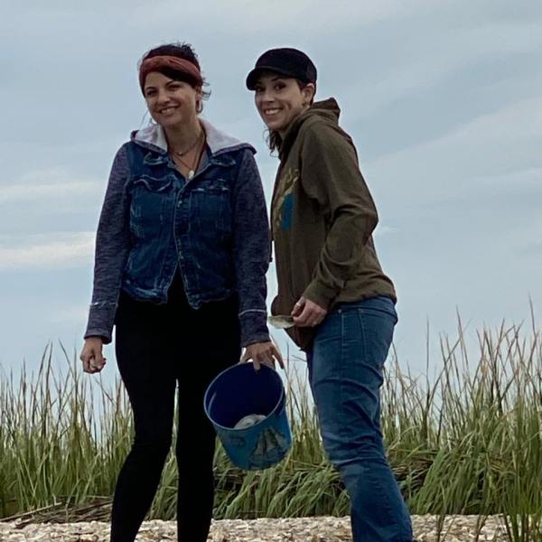 a man and a woman standing in the grass