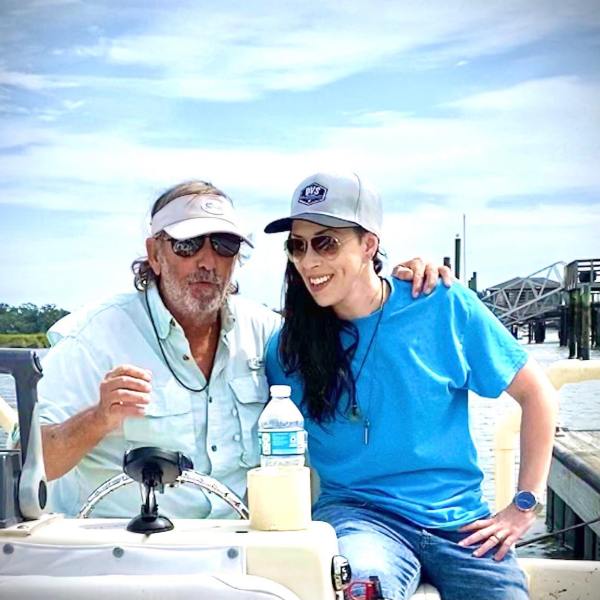 a man and a woman sitting on a boat