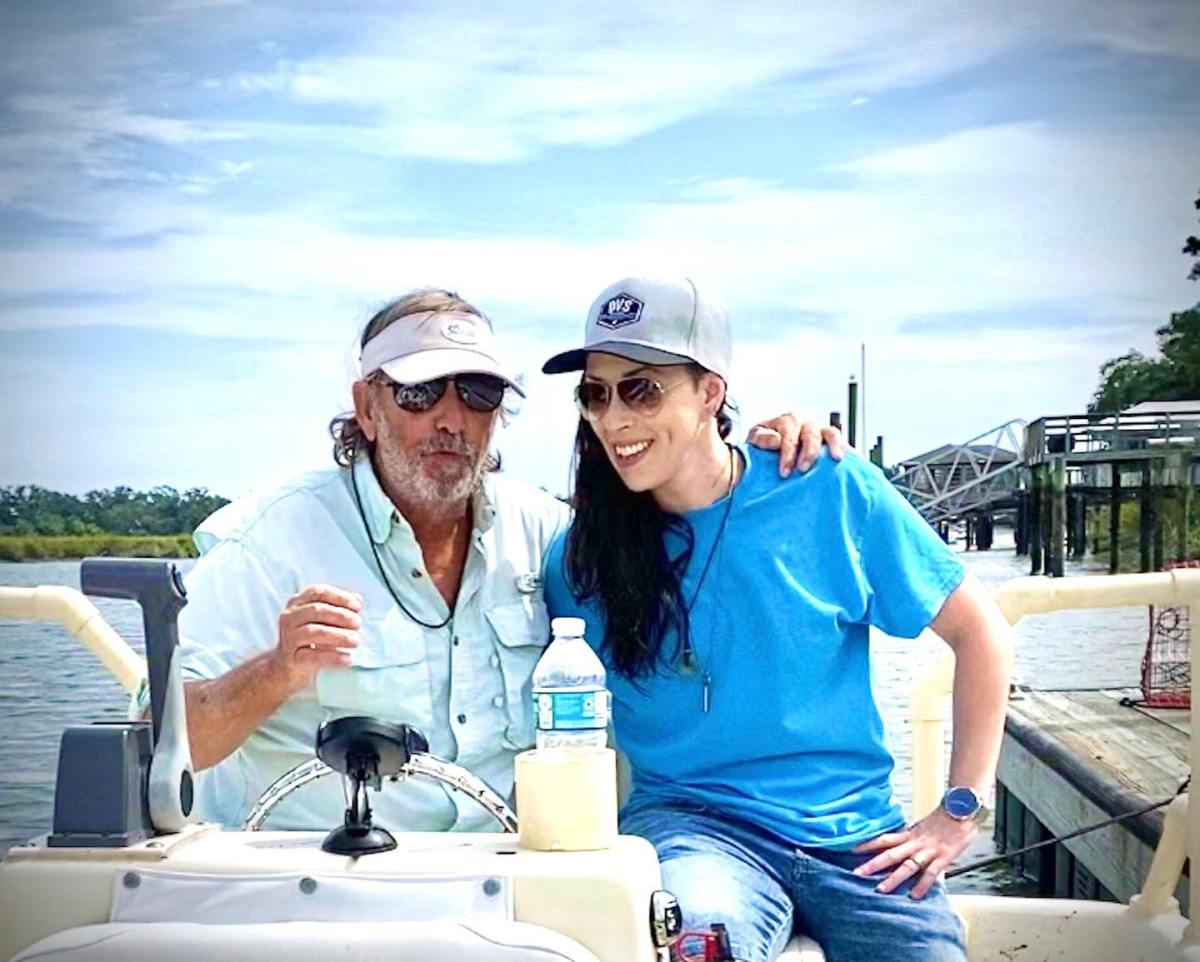 279160143_477719270807182_3985031523339751155_n a man and a woman sitting on a boat