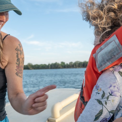 a woman standing next to a body of water
