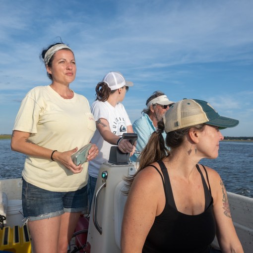a woman standing next to a body of water