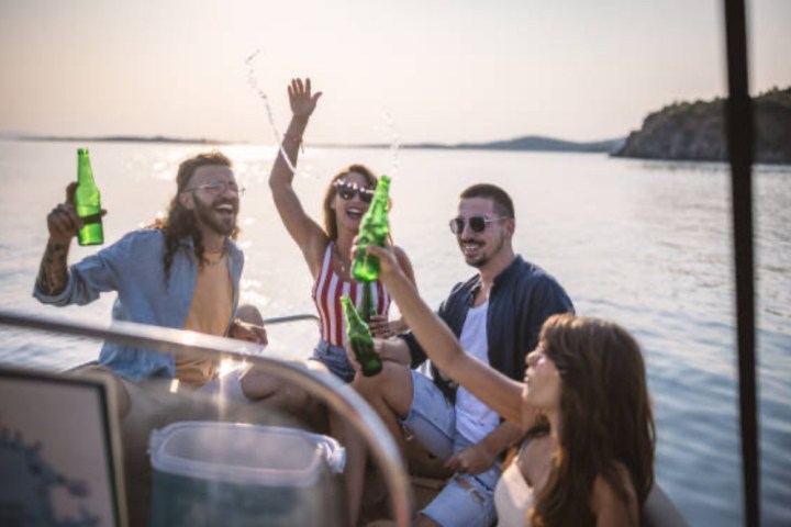 a group of people standing next to a body of water